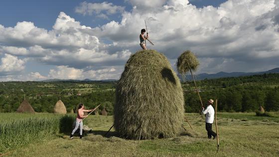 Whether being tended to by locals, dotting the countryside, or piled onto horse-drawn carts, you'll find haystacks all over the Romanian region of Maramureș. (Cameron Hewitt, Rick Steves' Europe)