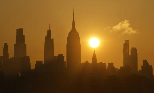 The sun rises over New York City as a heat wave arrives in June 2025. Gary Hershorn/Getty Images
