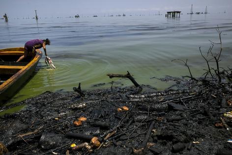 Oil spills from Venezuela’s neglected industry contaminate Lake Maracaibo in northwestern Venezuela. Scenes like this are what environmental and Indigenous groups fear if oil drilling expands in the Orinoco Oil Belt.
              AP Photo/Rodrigo Abd