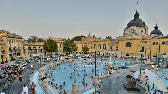 Budapest's Széchenyi Baths has stunning outdoor facilities — and hosts locals of all shapes and sizes squeezed into tiny swimsuits. (CREDIT: Cameron Hewitt, Rick Steves' Europe)