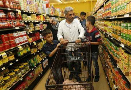 A Syrian refugee and his family shop for groceries in El Cajon, Calif., on Aug. 31, 2016.
              AP Photo/Lenny Ignelzi