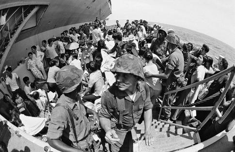 Vietnamese evacuees fill a landing craft, assisted by U.S. Marines, on May 4, 1975. More than 125,000 refugees from Vietnam were resettled in the U.S. between 1975 and 1980.
              AP Photo/Neal Ulevich