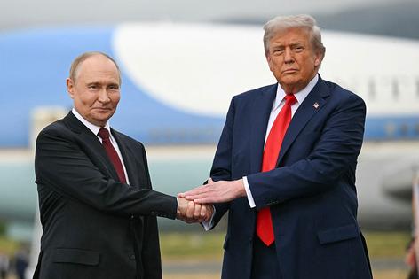 TOPSHOT - US President Donald Trump greets Russian President Vladimir Putin on the tarmac after they arrived at Joint Base Elmendorf-Richardson in Anchorage, Alaska, on August 15, 2025. Putin is in Alaska at the invitation of Trump in his first visit to a Western country since he ordered the 2022 invasion of Ukraine that has killed tens of thousands of people. (Photo by ANDREW CABALLERO-REYNOLDS / AFP via Getty Images)