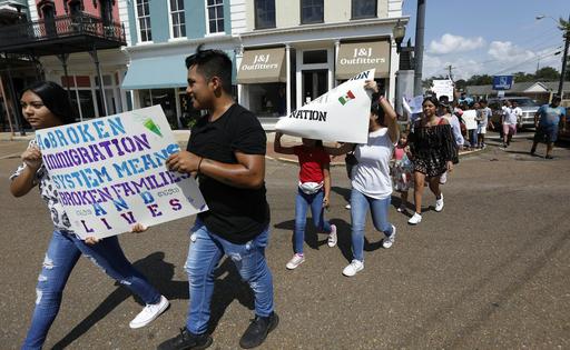 Young Latinos hold signs in support of workers picked up during a 2019 immigration raid at a food processing plant in Canton, Miss., following a Spanish Mass at Sacred Heart Catholic Church.
              AP Photo/Rogelio V. Solis