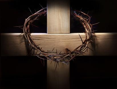 Crown of thorns and wooden cross. Crown of thorns hanging on wooden cross. Dreamstime/TCA
