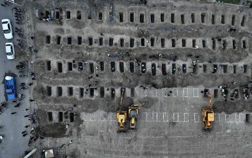 Graves dug for coffins of students killed in a bombing on a girls elementary school in Minab, Iran, are seen during a mass funeral on March 3, 2026.
              Stringer/Anadolu via Getty Images