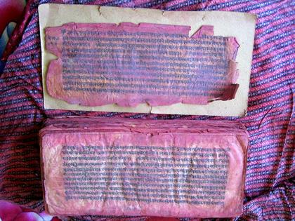 A handwritten Swasthani Vrata Katha manuscript that dates to 1922 and is discolored from being worshipped with red vermillion by devotees.
              Jessica Vantine Birkenholtz, CC BY-SA