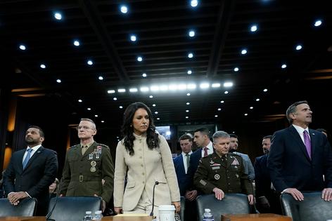 Director of National Intelligence Tulsi Gabbard, center, acting Commander of U.S. Cyber Command William Hartman and CIA Director John Ratcliffe, right, stand before the Senate Committee on Intelligence on Capitol Hill on March 18, 2026. AP Photo/Jose Luis Magana