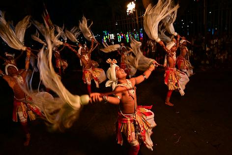 Traditional dancers perform in front of the Buddhist Temple of the Tooth, celebrating the Buddhist festival of Esala Perahera, in Kandy, Sri Lanka, on Aug. 8, 2025. Ishara S. Kodikara/AFP via Getty Images