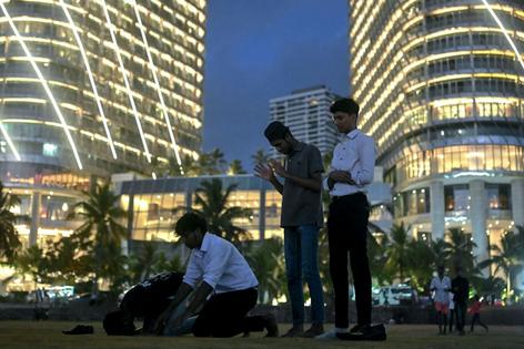 Muslim men offer prayers during sunset at the Galle Face beach in Colombo, Sri Lanka, on Sept. 24, 2024.
              Idrees Mohammed/AFP via Getty Images