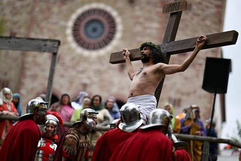 Actors and spectators take part in a re-enactment of the crucifixion of Jesus Christ on Good Friday in Bensheim, western Germany on April 18, 2025. Christian believers around the world mark the Holy Week of Easter remembering the crucifixion and resurrection of Jesus Christ. (Photo by Kirill KUDRYAVTSEV / AFP) (Photo by KIRILL KUDRYAVTSEV/AFP via Getty Images)