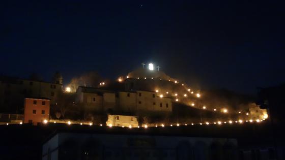 The dramatic finale of Cantiano's Passion Play leaves the center cross atop the town empty, save for a floodlit shroud blowing in the wind. (Rick Steves, Rick Steves' Europe)