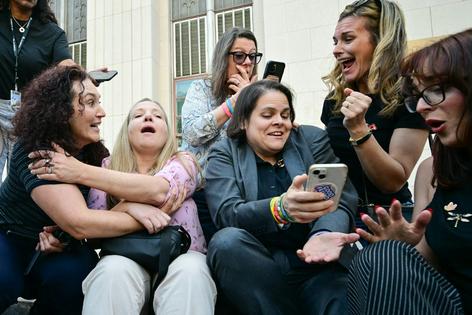 An attorney for, and family members of, child victims of social media harms react to the verdict in a lawsuit in Los Angeles on March 25, 2026.
              Frederic J. Brown/AFP via Getty Images
