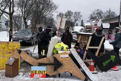 Anti-ICE protestors in Minneapolis built a barricade to monitor federal law enforcement vehicles traveling through the neighborhood.
              Star Tribune via Getty Images
