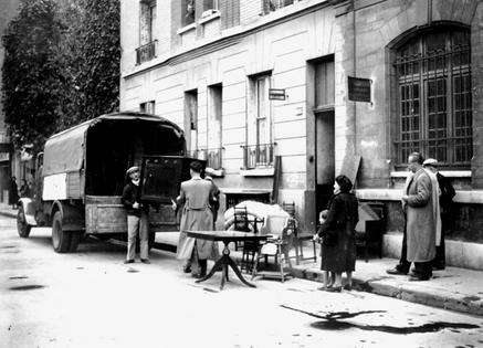 Furniture confiscated from Jewish homes is delivered to other people in Boulogne-Billancourt, Paris in April 1942, after an Allied bombing. Art Media/Print Collector/Getty Images