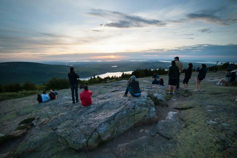 Watching the sunrise on Cadillac Mountain in Acadia National Park in Maine can be an enjoyable collective experience.
              Kent Miller/National Park Service