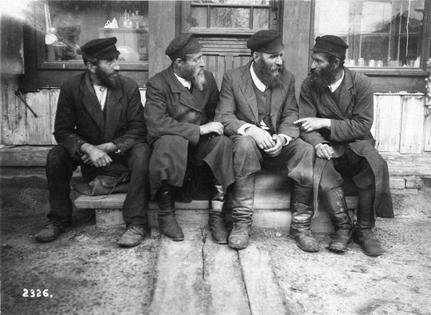 Jewish men chat outside a shop in Krasilov, Ukraine, in the early 1900s.
              History & Art Images via Getty Images