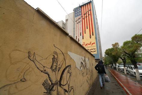 An Iranian walks past an anti-U.S. mural in Tehran on April 5, 2025. Atta Kenare/AFP via Getty Images