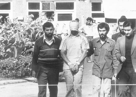 Iranian students at the U.S. Embassy in Tehran show a blindfolded American hostage to the crowd in November 1979.
AP Photo