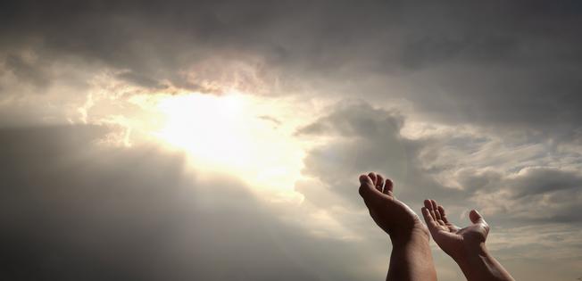 praying hands of a man for blessings his god on the sunset. Dreamstime/TCA