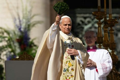 Pope Leo XIV uses hyssop sprigs to sprinkle holy water during Easter Mass in St. Peter’s Square at the Vatican on April 5, 2026.  AP Photo/Andrew Medichini