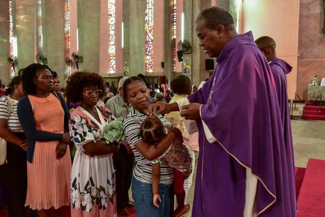 A priest marks Catholics’ foreheads with ashes during the Ash Wednesday Mass at Sagrada Familia Church in Luanda, Angola, on March 5, 2025.
              Julio Pacheco Ntela/AFP via Getty Images