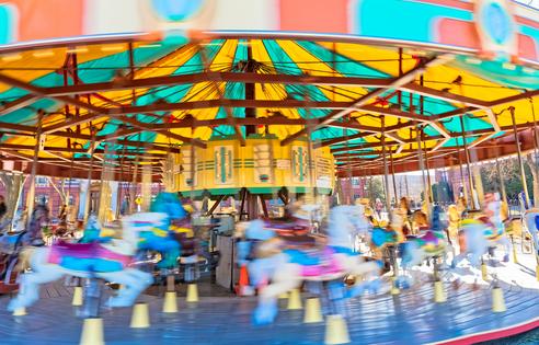 Colorful carousel in rotation in Washington DC public park. WASHINGTON, USA: Colorful carousel in rotation in National Mall park. Dreamstime/TCA