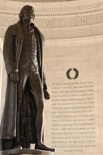 Interior of Jefferson Memorial in Washington DC with Jefferson on the left and an inscription from the Declaration of Independence on the right. Dreamstime/TCA