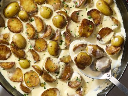 Enjoy tender, golden baby potatoes in a flavorful cream sauce with garlic and Parmesan. (Alex Lepe/TCA)
