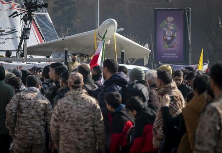 Revolutionary Guard personnel stand under an Iranian-made unmanned aerial vehicle, the Shahed-136, while participating in a military rally in Tehran, Iran, on Jan. 10, 2025.  Morteza Nikoubazl/NurPhoto via Getty Images