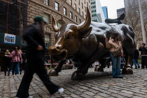 The Wall Street Bull stands in the Financial District, home to the New York Stock Exchange (NYSE), in Manhattan on March 19, 2026, in New York City. Global stocks reached new highs in mid-April on the promise of new talks to end the war in Iran. (Spencer Platt/Getty Images/TNS)