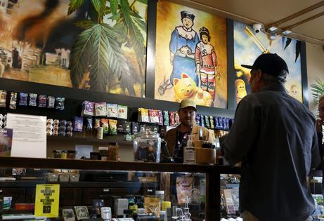 A budtender helps customers purchase marijuana at California Street Cannabis Company on Aug. 11, 2025, in San Francisco.
              Justin Sullivan/Getty Images