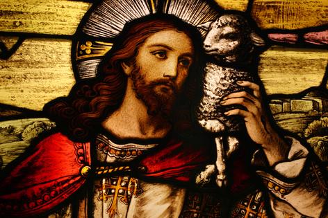 Jesus with Lamb. Stained glass depicting Jesus holding a lamb. Dreamstime/TCA