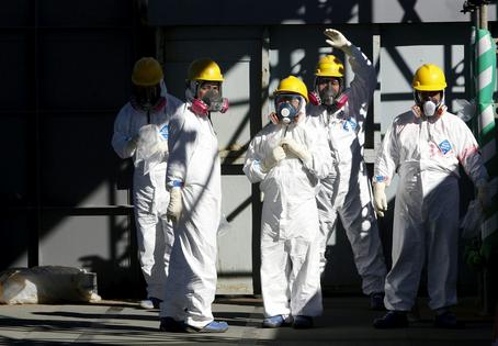 People working on the cleanup of the Fukushima Daiichi disaster wear protective clothing to reduce their risk of exposure and contamination.
              AP Photo/Issei Kato