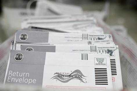 Mail-in ballots in their envelopes await processing at the Los Angeles County Registrar-Recorder's mail-in ballot processing center in Pomona, Calif., on Oct. 28, 2020. Robyn Beck / AFP via Getty Images