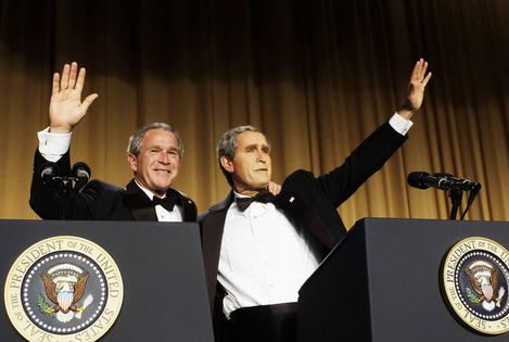 TOPSHOT - US President George W. Bush (L) waves with comedian Steve Bridges, who is impersonating him, at the White House Correspondents' Association Dinner, 29 April 2006, at the Washington Hilton Hotel in Washington, DC. (Photo by Mandel NGAN / AFP) (Photo by MANDEL NGAN/AFP via Getty Images)
