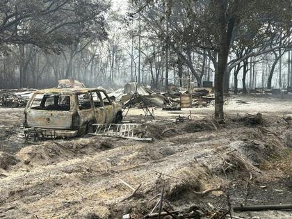 A fire near the Florida-Georgia line had burned nearly 30,000 acres by April 23, 2026, leaving ash behind.
              Georgia Department of Natural Resources via AP