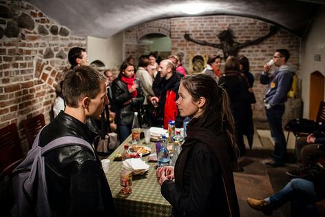 People chat during a meeting after a Mass for singles in the Jesuit church in Warsaw, Poland, on Sept. 24, 2013.
              Wojtek Radwanski/AFP via Getty Image
