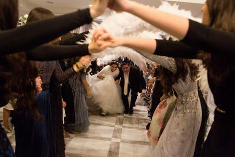 A young Orthodox Jewish couple get married at a banquet hall in the Manhattan Beach neighborhood of Brooklyn, N.Y., in 2019.
              Andrew Lichtenstein/Corbis via Getty Images