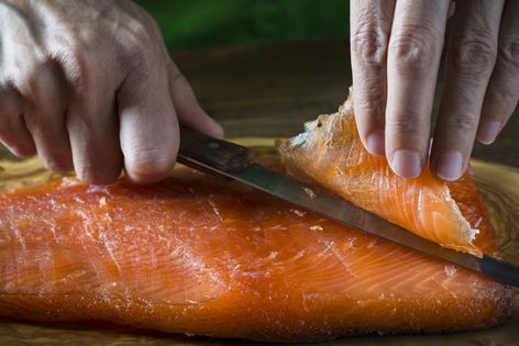 Make sure to have a very sharp knife to slice the salmon. (Dreamstime/TCA)