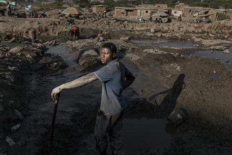 A family works at an artisanal cobalt and copper mine site in 2025 in Kolwezi, Democratic Republic of the Congo. These mines are often unregulated.
              Michel Lunanga/Getty Images