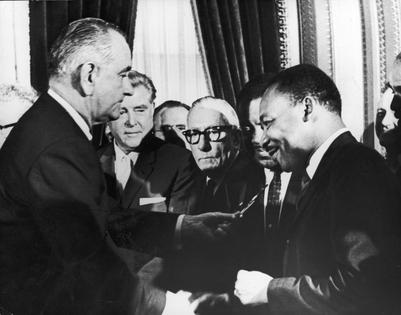 President Lyndon Johnson hands a pen to civil rights leader Rev. Martin Luther King Jr. during the signing of the Voting Rights Act in Washington,  D.C., on Aug. 6, 1965.  Hulton Archive, Washington Bureau/Getty Images
