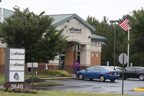 A customer walks out of a credit union in Virginia where a robbery in 2019 set in motion events that led to a Supreme Court case.
              AP Photo/Steve Helber