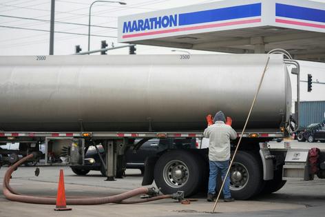 A tanker truck delivers fuel to a gas station.
              AP Photo/Erin Hooley