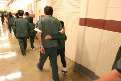 Families and their children walk along the halls of the T. Don Hutto Residential Center in Taylor, Texas, an ICE detention facility for families.
              Robert Daemmrich Photography Inc/Corbis via Getty Images