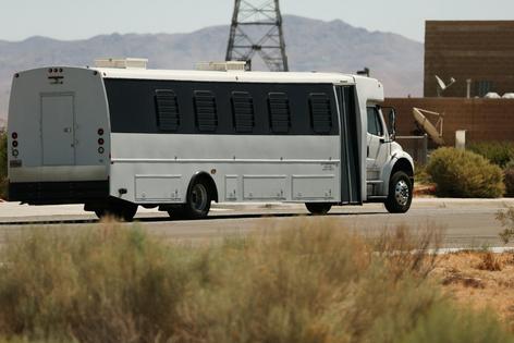 A shuttle bus transports detainees outside the private prison company GEO Group’s ICE detention facility in Adelanto, Calif., on July 11, 2025.
              Patrick T. Fallon/AFP via Getty Images