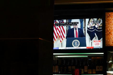 A TV displays U.S. President Donald Trump's prime-time address on the war in Iran inside a Cheesecake Factory on April 1, 2026, in Washington, D.C.  Anna Moneymaker/Getty Images