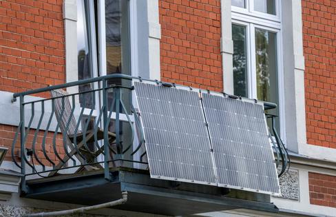 Small-scale solar panels mounted on balconies can help more households use renewable energy. Jens Büttner/picture alliance via Getty Images