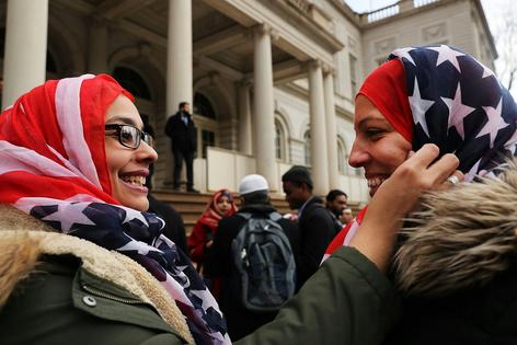 Two police officers wear American flag head scarfs at a World Hijab Day event on Feb. 1, 2017, in New York City. Spencer Platt/Getty Images