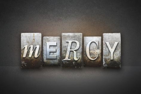 The word MERCY written in vintage letterpress type. Dreamstime/TCA
